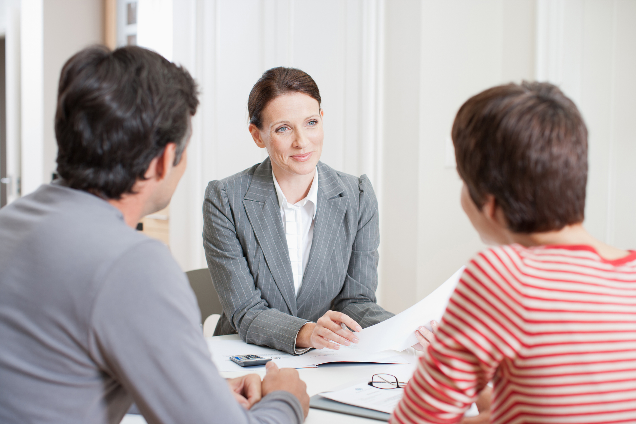Couple consulting with female professional