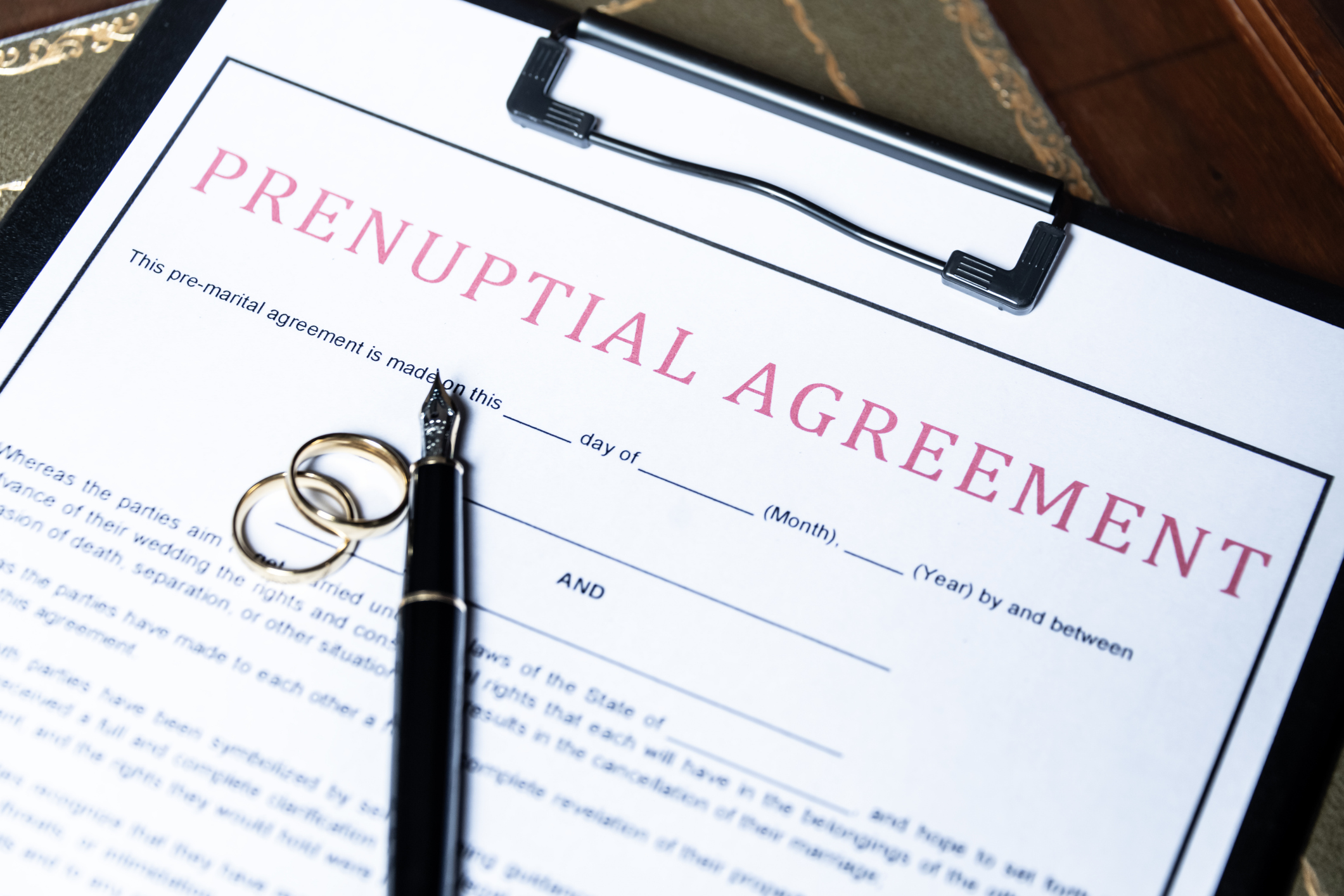 Pen and prenuptial agreement on clipboard