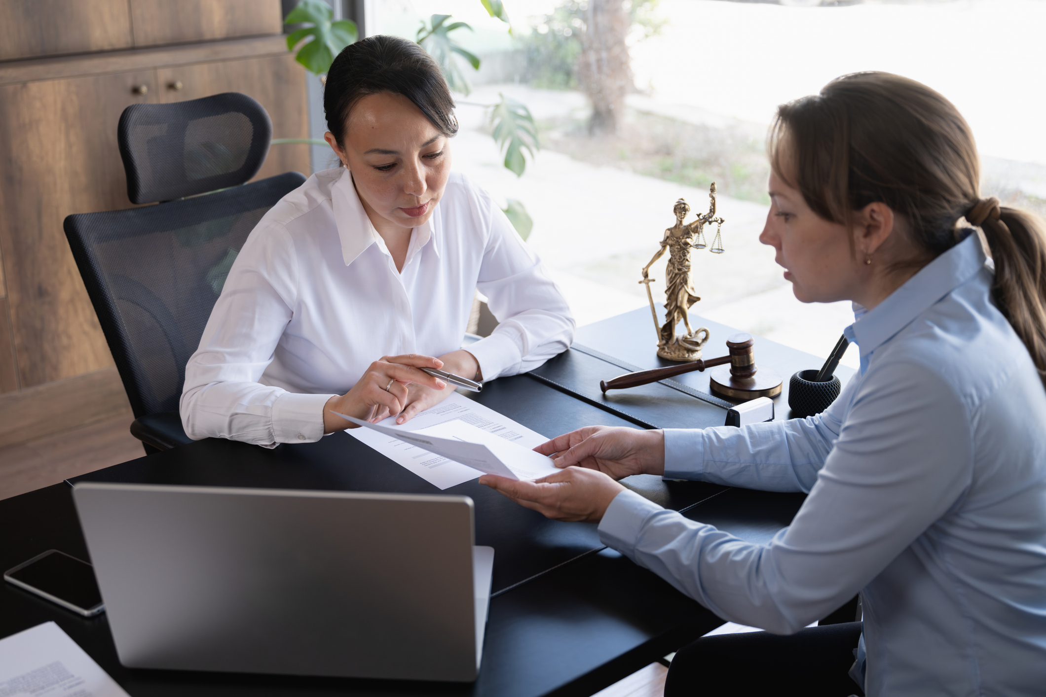 Lawyer consulting client with legal documents