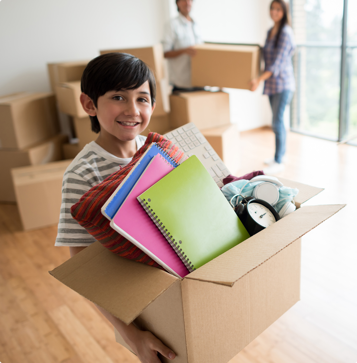 Happy child helping with moving boxes