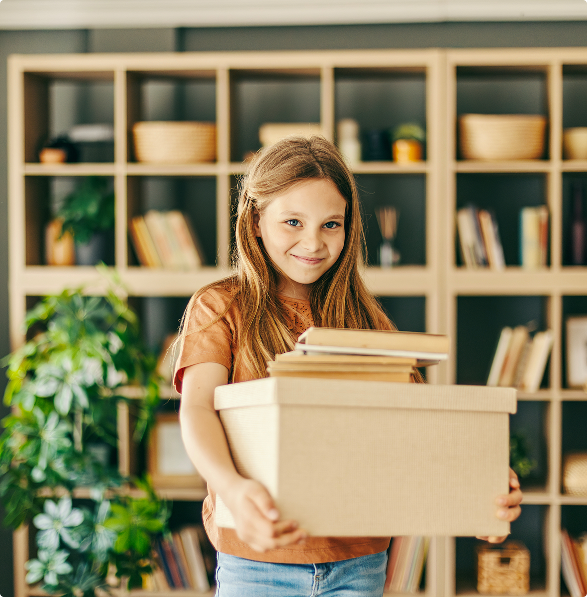 Girl carrying box of books