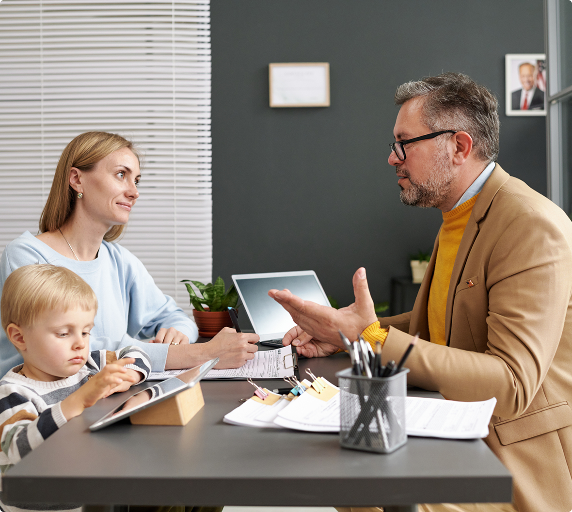Mother, child, and advisor discussing finances